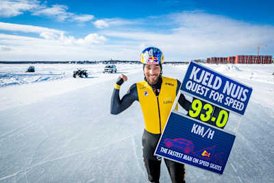 Kjeld Nuis holds a sign with his official speed of 93kph after setting a new world speed skating record.