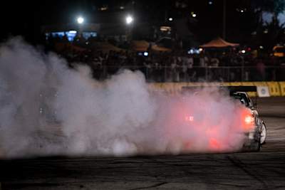 A photo of a drifting competitor burning rubber during Red Bull Car Park Drift in Amman, Jordan on August 16, 2019.