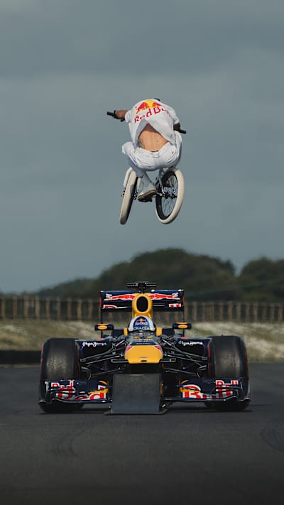 Kriss Kyle jumps over a F1 car in incredible video.
