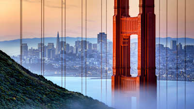 San Francisco skyline seen through golden Gate Bridge.
