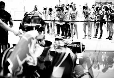 Media waits outside the garage of Sebastian Vettel of Germany and Infiniti Red Bull Racing during practice for the Formula One Grand Prix of India
