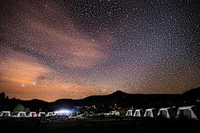 Campsite and tents for Race the Planet competitors under starry sky.