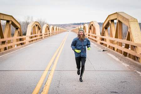 Ultrarunner Rob Pope runs across a bridge on Old Route 66 in the USA.