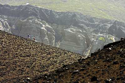 Hikers walk a route towards the Capelinhos Volcano on the island of Faial in the Azores.