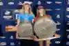 Caity Simmers and Molly Picklum with their Gold Coast pro trophies.