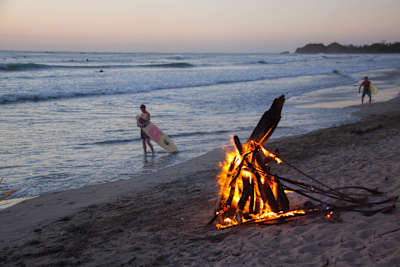 Bonfire and surfers on Playa Guiones on Guanacaste, Costa Rica.