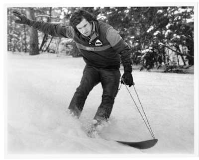 Jake riding an early version of a snowboard controlled by a rope