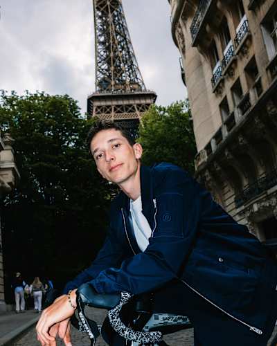 Red Bull - BORA - hansgrohe rider Florian Lipowitz poses with his bike near the Eiffel Tower during a Paris photo shoot on July 28, 2025, showcasing cycling excellence
