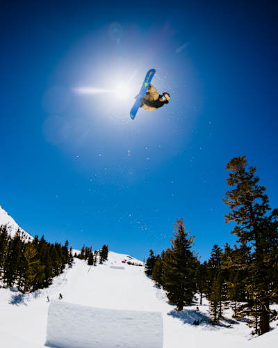 In 2023, Hiroto Ogiwara snowboarding at Red Bull Snow Team Session in Mammoth Lakes, against a pristine mountain backdrop.
