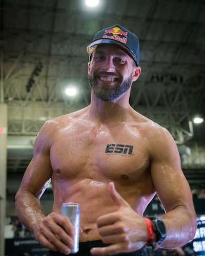 HYROX Elite 15 athlete Alexander Rončević smiling with a can of Red Bull in his hands