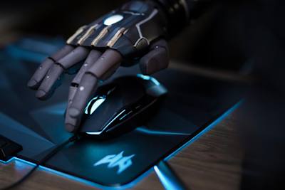 An image of Daniel Melville gaming with his bionic arm