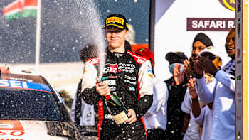 Kalle Rovanperä celebrates on the podium after winning Safari Rally Kenya on June 26, 2022.