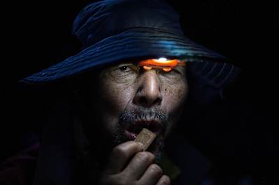 Competitor with head torch eats chocolate at night at Racing the Planet Patagonia.
