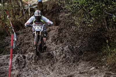 Rider battles muddy conditions during Fort William World Cup.