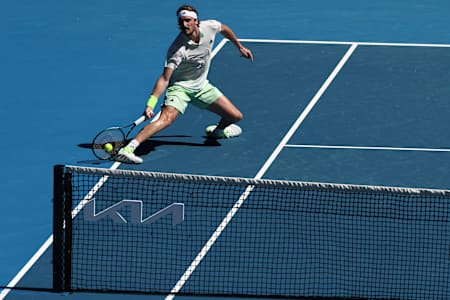 Stefanos Tsitsipas golpea una devolución contra el belga Zizou Bergs durante su partido individual masculino del segundo día del Open de Australia de tenis en Melbourne, el 15 de enero de 2024.