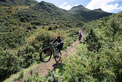 MTBers wheelie through a mountain bike trail in Lesotho.