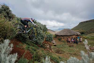Matt Jones rides his bike towards village house in Lesotho.