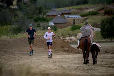 Ryan Sandes an Ryno Griesel meet some friendly Basotho Locals during their Trail Running project Navigate Lesotho