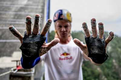 Thomas van Tonder holds up his damaged hand protection after Red Bull Bridge Bars at Bloukrans Bridge in South Africa in October 2026. 