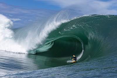 The fleeting harmony of humanity and nature in full force as Justine Dupont takes on a Polynesian monster wave. Note the height of the impact spray on the left of shot.