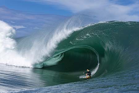The fleeting harmony of humanity and nature in full force as Justine Dupont takes on a Polynesian monster wave. Note the height of the impact spray on the left of shot.