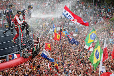A photo of Sebastian Vettel, Fernando Alonso and Mark Webber on the podium after the 2013 Italian Formula One Grand Prix.