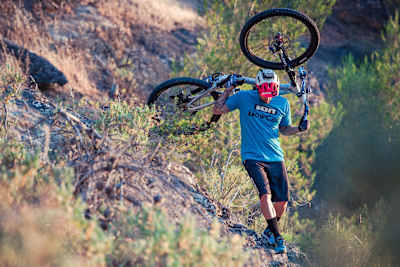 David Cachon carries his MTB on an unrideable section of the famous El Caminito del Rey near Malaga, Spain