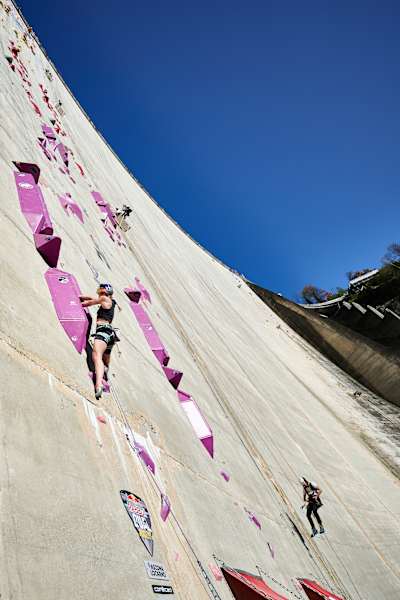 In 2024, Jessica Pilz climbs a towering man-made rock route at Verzasca Dam during Red Bull Dual Ascent finals in Switzerland