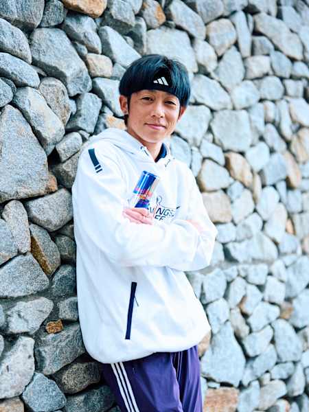 Wings for Life World Run record holder Jo Fukuda from Japan holding a can of Red Bull