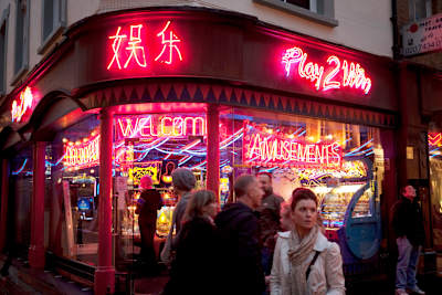 Night time scene outside an amusement arcade in Chinatown, Soho, London, 2010. Here people can bet on small gaming machines and play on video games.