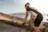 A bike rider goes up a climb standing on his pedals.