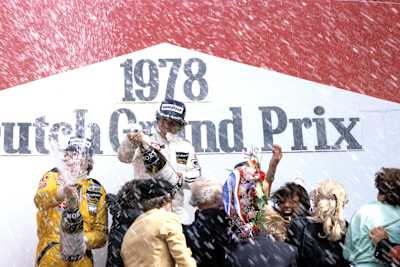 A photo of Mario Andretti and Ronnie Peterson celebrating on the podium after the 1978 Grand Prix Of The Netherlands.