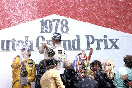 A photo of Mario Andretti and Ronnie Peterson celebrating on the podium after the 1978 Grand Prix Of The Netherlands.