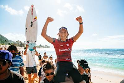 Molly Picklum is lifted to the podium after winning the Hurley Pro Sunset Beach in Hawaii. 