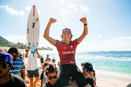 Molly Picklum is lifted to the podium after winning the Hurley Pro Sunset Beach in Hawaii. 
