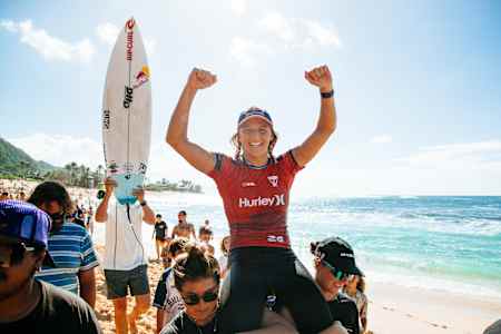 Molly Picklum is lifted to the podium after winning the Hurley Pro Sunset Beach in Hawaii. 