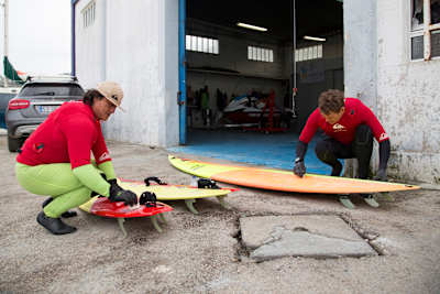 Ross Clarke Jones and Jamie Mitchell prepare their surfboards 