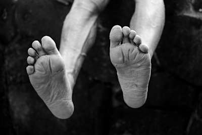 Braden Currie's feet, close up black and white.