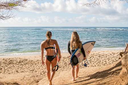 An image of surfers Caroline Marks and Carissa Moore.