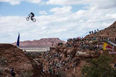 A mountain biker performing a gap jump at Red Bull Rampage.