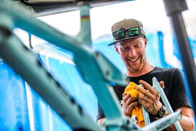 Trek Factory Racing team mechanic Joe Krejbich cleans Rachel Atherton's Trek MTB at a World Cup race.