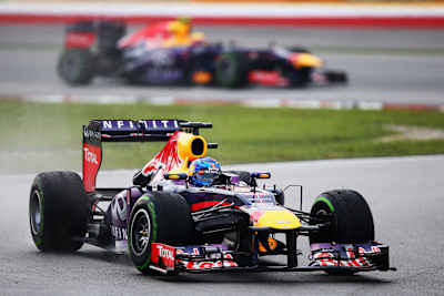 An image of Sebastian Vettel leading Mark Webber at the 2013 F1 Malaysian Grand Prix at the Sepang Circuit in Kuala Lumpur.