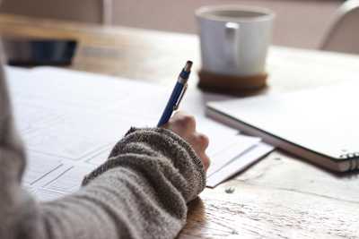 A photo of someone completing written exam.