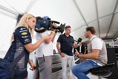 A photo of David Croft stood up interviewing Red Bull Racing team principal Christian Horner at Goodwood in 2015.