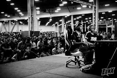Tekken pro player Cuddle Core performs on stage in an esports tournament.