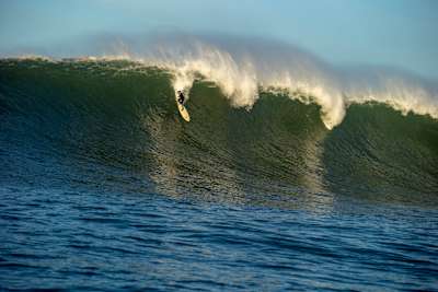 Justine Dupont taking off on a big wave at Mavericks, California