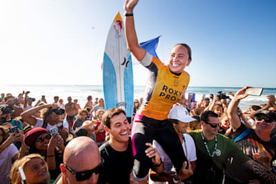 Carissa Moore getting chaired up the beach by husband Luke Untermann after winning the 2019 Roxy Pro France