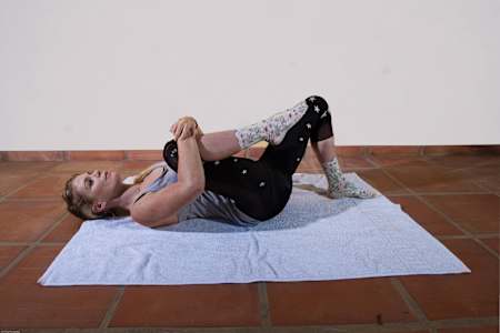 Anna Glowinski demonstrates stretches for cyclists.