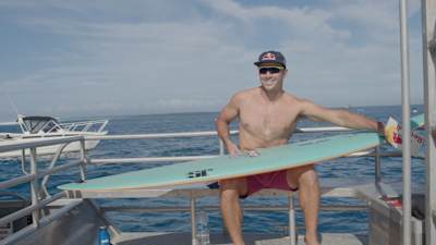 Julian Wilson waxes up his surfboard in Fiji. 