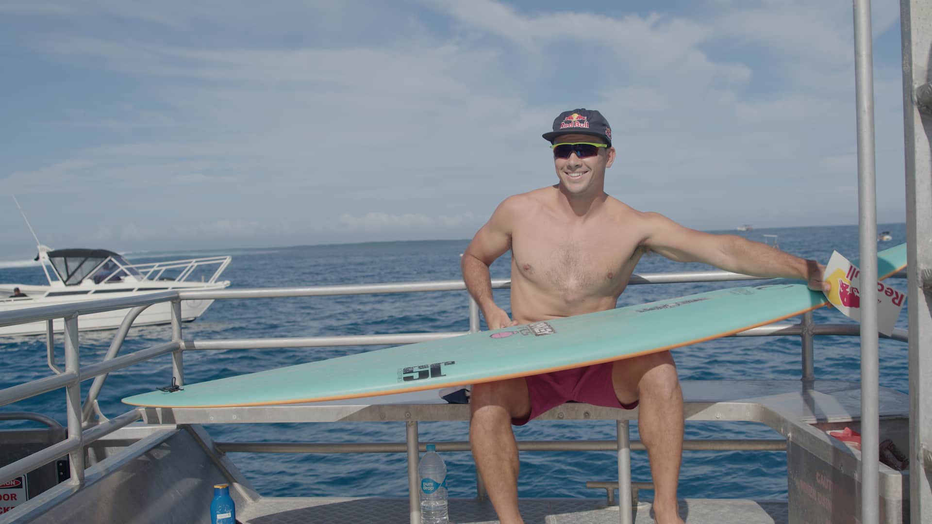 Julian Wilson waxes up his surfboard in Fiji. 